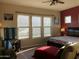 Spacious bedroom with three large windows, a king-size bed, and a relaxing atmosphere at 16221 S 35Th Dr, Phoenix, AZ 85045