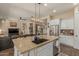 Open kitchen with granite island, stainless steel appliances, and views to living area at 16221 S 35Th Dr, Phoenix, AZ 85045