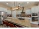 Spacious kitchen with granite island, stainless steel appliances, and light cabinets at 16221 S 35Th Dr, Phoenix, AZ 85045