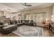 Spacious living room featuring a large sectional sofa and wood-look floors at 16221 S 35Th Dr, Phoenix, AZ 85045
