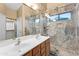 Updated bathroom with double vanity and walk-in shower at 16671 W Mckinley St, Goodyear, AZ 85338