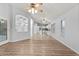 Living room with wood-look floors, leading to kitchen at 16671 W Mckinley St, Goodyear, AZ 85338