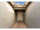 Light-colored entryway with terracotta flooring and a door to the house at 1922 N Wildflower Ln, Casa Grande, AZ 85122