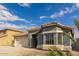 Single-story home with a two-car garage and neutral-colored exterior at 1922 N Wildflower Ln, Casa Grande, AZ 85122