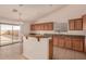 Kitchen features wood cabinets, granite countertops, and stainless steel appliances at 1922 N Wildflower Ln, Casa Grande, AZ 85122