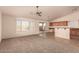 Open concept kitchen and living area with tile and carpet flooring, and a breakfast bar at 1922 N Wildflower Ln, Casa Grande, AZ 85122