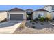 Single-story home with two-car garage and nicely landscaped front yard at 19231 W Missouri Ave, Litchfield Park, AZ 85340