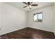 Bright bedroom featuring dark wood-look flooring and ceiling fan at 1993 S Buena Vista Dr, Apache Junction, AZ 85120