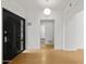 Bright entryway with modern black door and light hardwood floors at 23005 N 87Th St, Scottsdale, AZ 85255