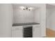 Modern wet bar with marble herringbone tile and wine cooler at 23005 N 87Th St, Scottsdale, AZ 85255