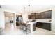 Modern kitchen with island and breakfast bar, dark cabinetry, and stainless steel appliances at 2389 E Hazeltine Way, Gilbert, AZ 85298