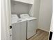 Convenient laundry room featuring a washer, a dryer, and a storage shelf at 24098 W Sunland Ave, Buckeye, AZ 85326