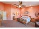 Spacious bedroom with carpeted floor and wooden furniture at 2419 S 200Th Ln, Buckeye, AZ 85326