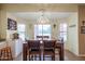 Bright dining area with a wood table and chairs, adjacent to kitchen at 2419 S 200Th Ln, Buckeye, AZ 85326