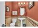 Updated bathroom with pedestal sink, toilet and tiled accents at 2458 E Roma Ave, Phoenix, AZ 85016
