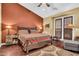 Spacious bedroom with hardwood floors and a king-size bed at 2458 E Roma Ave, Phoenix, AZ 85016