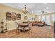 Charming dining area with a round table and chairs, adjacent to living room at 2458 E Roma Ave, Phoenix, AZ 85016