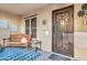Charming front entry with decorative door and welcoming sitting area at 2458 E Roma Ave, Phoenix, AZ 85016