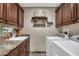 Laundry room with washer, dryer, and built-in cabinets at 2458 E Roma Ave, Phoenix, AZ 85016