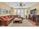 Comfortable living room with a large sectional sofa and access to outdoor space at 2458 E Roma Ave, Phoenix, AZ 85016