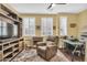 Home office with built-in shelving, comfortable chair and large screen TV at 2458 E Roma Ave, Phoenix, AZ 85016