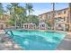 Community pool with cabanas and surrounding palm trees at 2458 E Roma Ave, Phoenix, AZ 85016