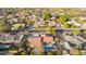 An aerial view showing the neighborhood, mature landscaping, pool, patio and roof of a house at 3457 E Ellis St, Mesa, AZ 85213