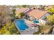 The backyard oasis is complete with a private pool, patio seating, and a grassy play area at 3457 E Ellis St, Mesa, AZ 85213