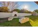 This backyard has an outdoor fireplace and built-in seating area is ideal for entertaining guests at 3457 E Ellis St, Mesa, AZ 85213