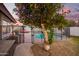 A tree with ripe oranges beside the pool area adds a splash of color to the outdoor space at 3457 E Ellis St, Mesa, AZ 85213