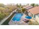 View of a private backyard with a swimming pool, lounge area, and well-maintained landscaping, with fencing at 3457 E Ellis St, Mesa, AZ 85213