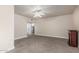 Open bedroom featuring an electric fireplace, neutral carpet and walls, and a ceiling fan at 3457 E Ellis St, Mesa, AZ 85213