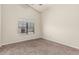 Bedroom featuring neutral walls, carpeted floors, and a window view of lush greenery at 3457 E Ellis St, Mesa, AZ 85213