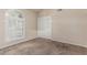 Bedroom featuring a double door closet, arched window, and neutral walls with carpeted flooring at 3457 E Ellis St, Mesa, AZ 85213