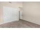 Neutral bedroom features carpeted floors, a ceiling fan, and a large closet with double doors at 3457 E Ellis St, Mesa, AZ 85213