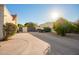 Long driveway leading to a gate, with mature trees and landscaping in a sunny setting at 3457 E Ellis St, Mesa, AZ 85213