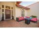 Inviting front patio with cozy seating area, decorative lion statues, and a stylish front door at 3457 E Ellis St, Mesa, AZ 85213