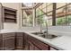 Spacious kitchen with stainless steel sink, dark cabinets, and sunlit window at 3457 E Ellis St, Mesa, AZ 85213