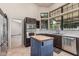 Open-concept kitchen with stainless steel appliances, an island, and dark wood cabinetry at 3457 E Ellis St, Mesa, AZ 85213