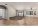 Bright living room featuring tile and carpet flooring, large windows, and neutral paint palette at 3457 E Ellis St, Mesa, AZ 85213
