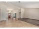Open-concept living room with tile flooring, carpeted area, and plenty of natural light at 3457 E Ellis St, Mesa, AZ 85213