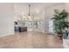 Bright and airy living area with tile flooring, kitchen access, and multiple windows for natural light at 3457 E Ellis St, Mesa, AZ 85213