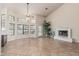 Bright living room featuring tile flooring, fireplace, and many windows with a view to the outdoors at 3457 E Ellis St, Mesa, AZ 85213