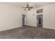 Spacious living room with carpet flooring, a ceiling fan, and ample natural light at 3457 E Ellis St, Mesa, AZ 85213