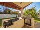 Patio outdoor kitchen with a gas and charcoal grill and a stucco base at 3457 E Ellis St, Mesa, AZ 85213