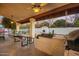 Outdoor patio kitchen with outdoor grill, concrete countertops and view of the fireplace and patio at 3457 E Ellis St, Mesa, AZ 85213