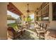 Inviting covered patio features comfortable seating and a built-in fireplace, perfect for outdoor relaxation at 3457 E Ellis St, Mesa, AZ 85213