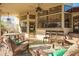 Covered patio with ceiling fans and ample seating, creating a cozy outdoor living space at 3457 E Ellis St, Mesa, AZ 85213