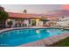 Inviting backyard pool with a diving board and lounge chairs, perfect for summer fun at 3457 E Ellis St, Mesa, AZ 85213