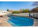 Refreshing backyard pool with diving board, slide, and basketball hoop, perfect for summer fun at 3457 E Ellis St, Mesa, AZ 85213